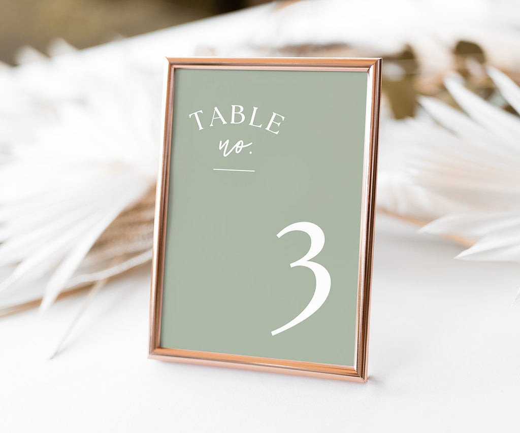 Sage Green Table Number Card shown in a rose gold frame set on a wedding table